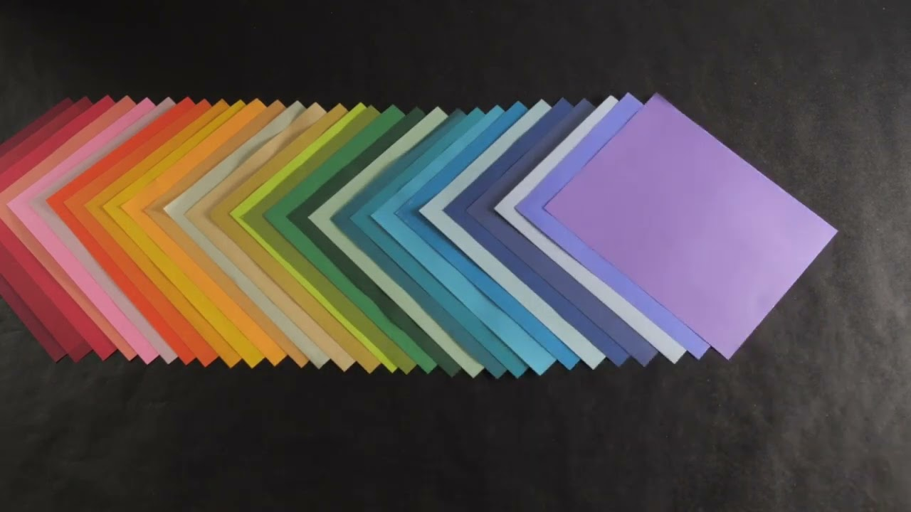 a row of sheets of colored paper overlapping one another on a black background